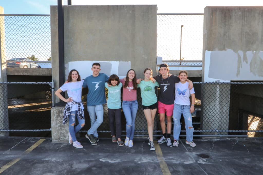 Teens wearing inspirational t shirts on rooftop